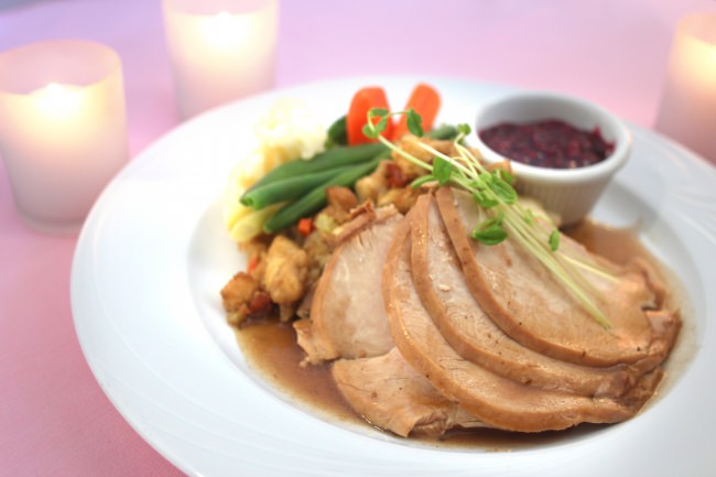 Traditional Roast Tom Turkey with Sage Apple Sausage Stuffing topped with Pan Gravy